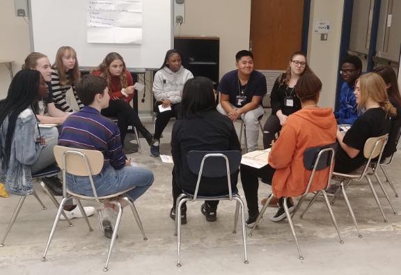 High school students from multiple schools engaging in dialogue through the Community Wide Dialogue program.
